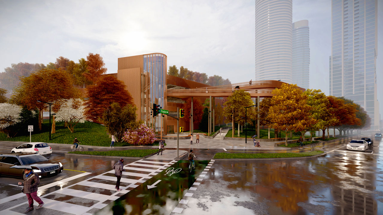 Concept artistique du stationnement à étages du nouveau campus de L’Hôpital d’Ottawa un jour d’automne pluvieux. Cernée d’arbres, l’entrée du stationnement à étages a de grandes fenêtres montrant la cage d’escaliers sur plusieurs étages à l’intérieur. Des voitures sont stationnées sur le côté de la rue et d’autres sont à l’arrêt à l’intersection de la rue Preston et de la promenade Prince of Wales. Des piétons traversent l’intersection et passent devant l’édifice.